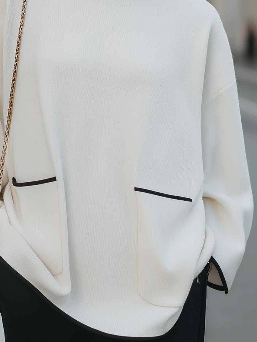 High-Neck Relaxed Sweater With Black Trim And Button Accents
