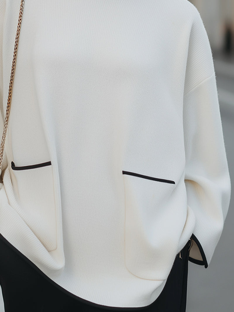 High-Neck Relaxed Sweater With Black Trim And Button Accents