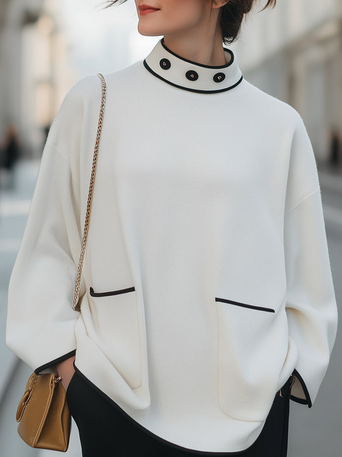 High-Neck Relaxed Sweater With Black Trim And Button Accents