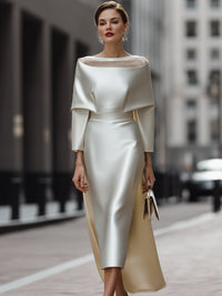 An Elegant Off-The-Shoulder Satin Cape Dress With A Sheer Neckline.