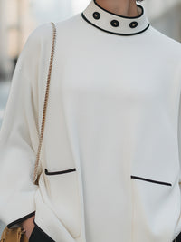 High-Neck Relaxed Sweater With Black Trim And Button Accents