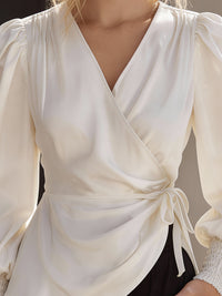 Elegant Cream Wrap Blouse With Lantern Sleeves And Smocked Cuffs