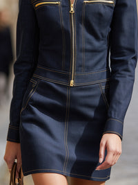 A Dark Indigo Zip-up Denim Top Paired With A Skirt Offers A Refined