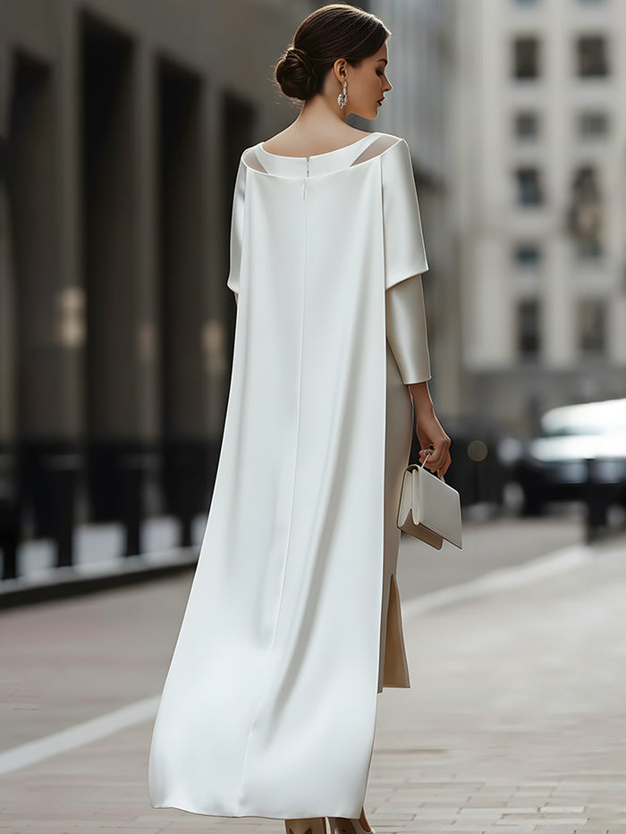 An Elegant Off-The-Shoulder Satin Cape Dress With A Sheer Neckline.
