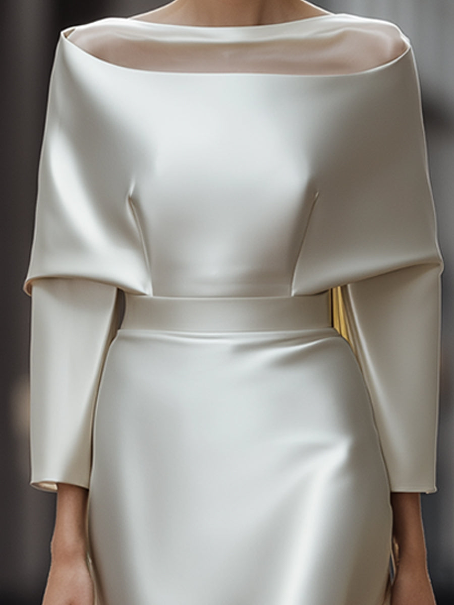 An Elegant Off-The-Shoulder Satin Cape Dress With A Sheer Neckline.