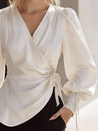 Elegant Cream Wrap Blouse With Lantern Sleeves And Smocked Cuffs